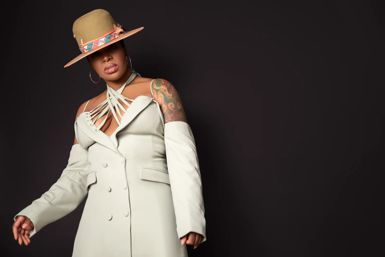 Ta'Rhonda Jones in a cream suit and hat