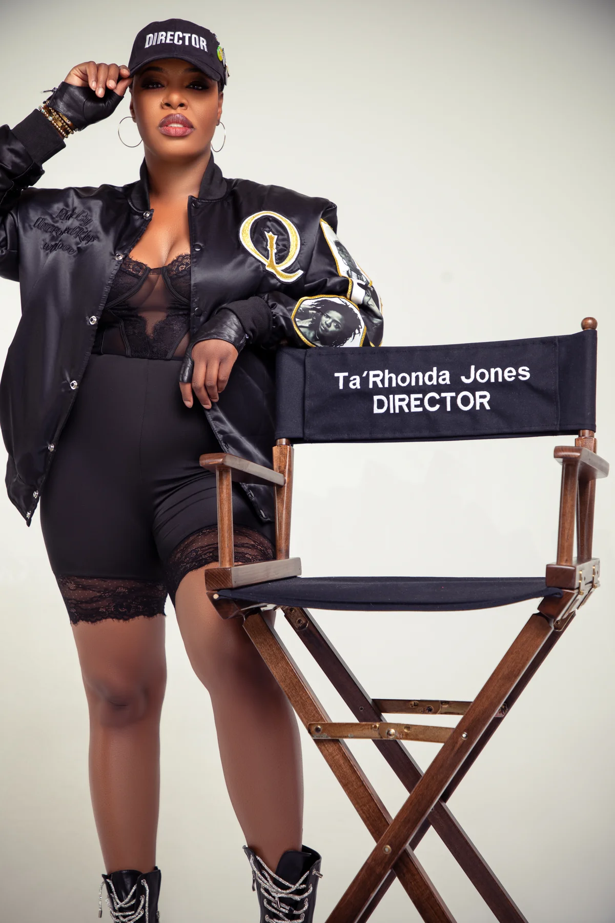 Ta'Rhonda Jones in a Director cap beside her personalized director's chair