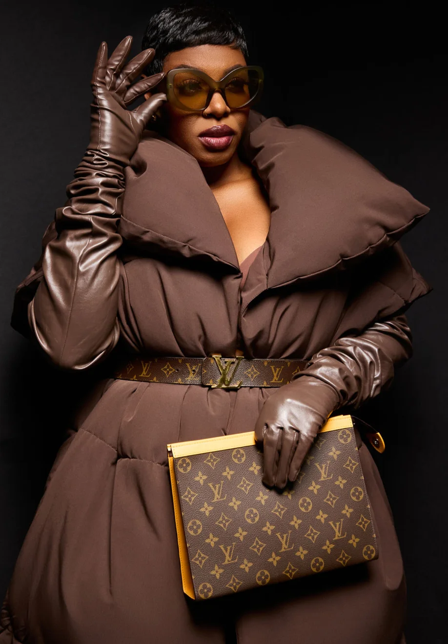 Ta'Rhonda Jones in oversized sunglasses and a brown puffer coat